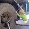 Kid fixes truck wheel 